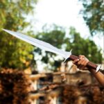 Gladius sword inside custom-fit leather scabbard with belt loop